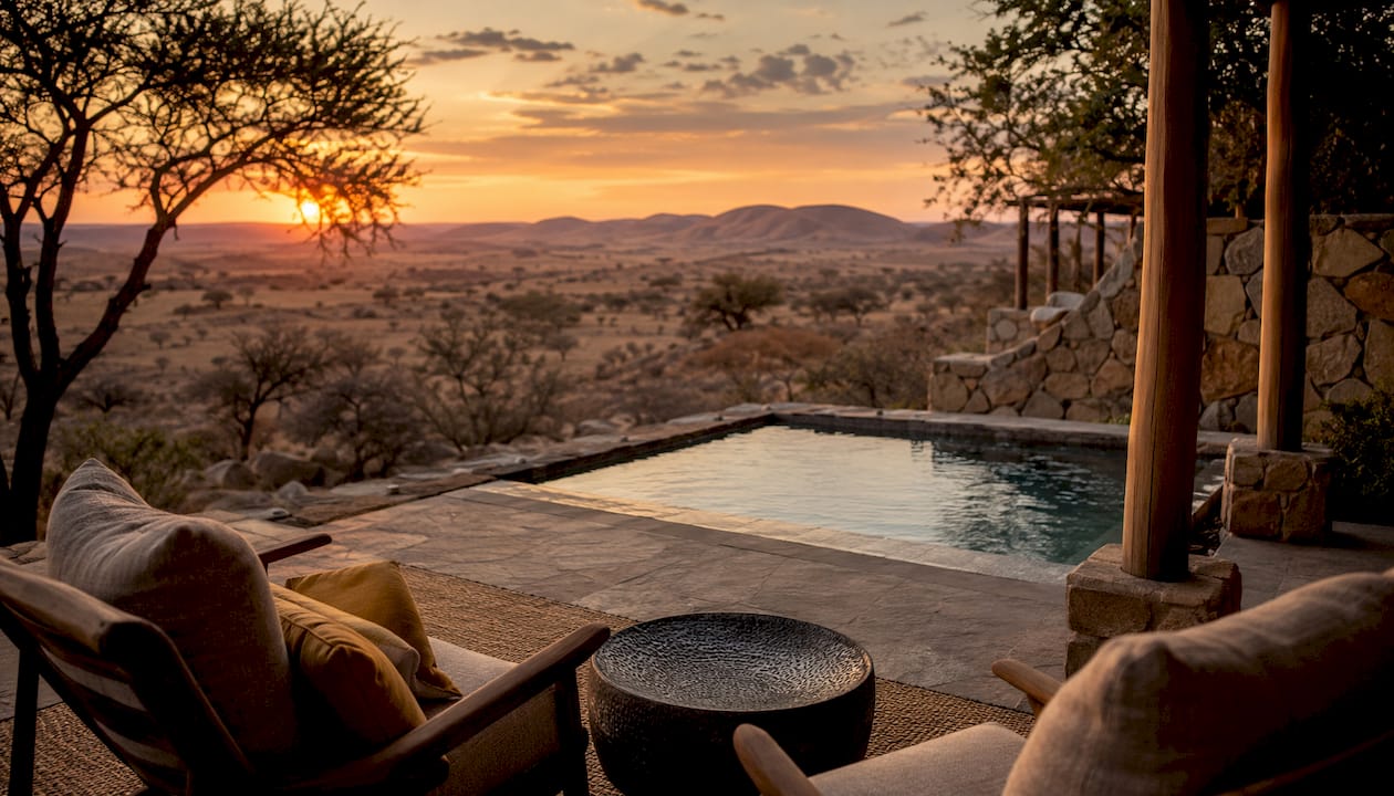 Elegant suite balcony overlooking desert plains at sunrise