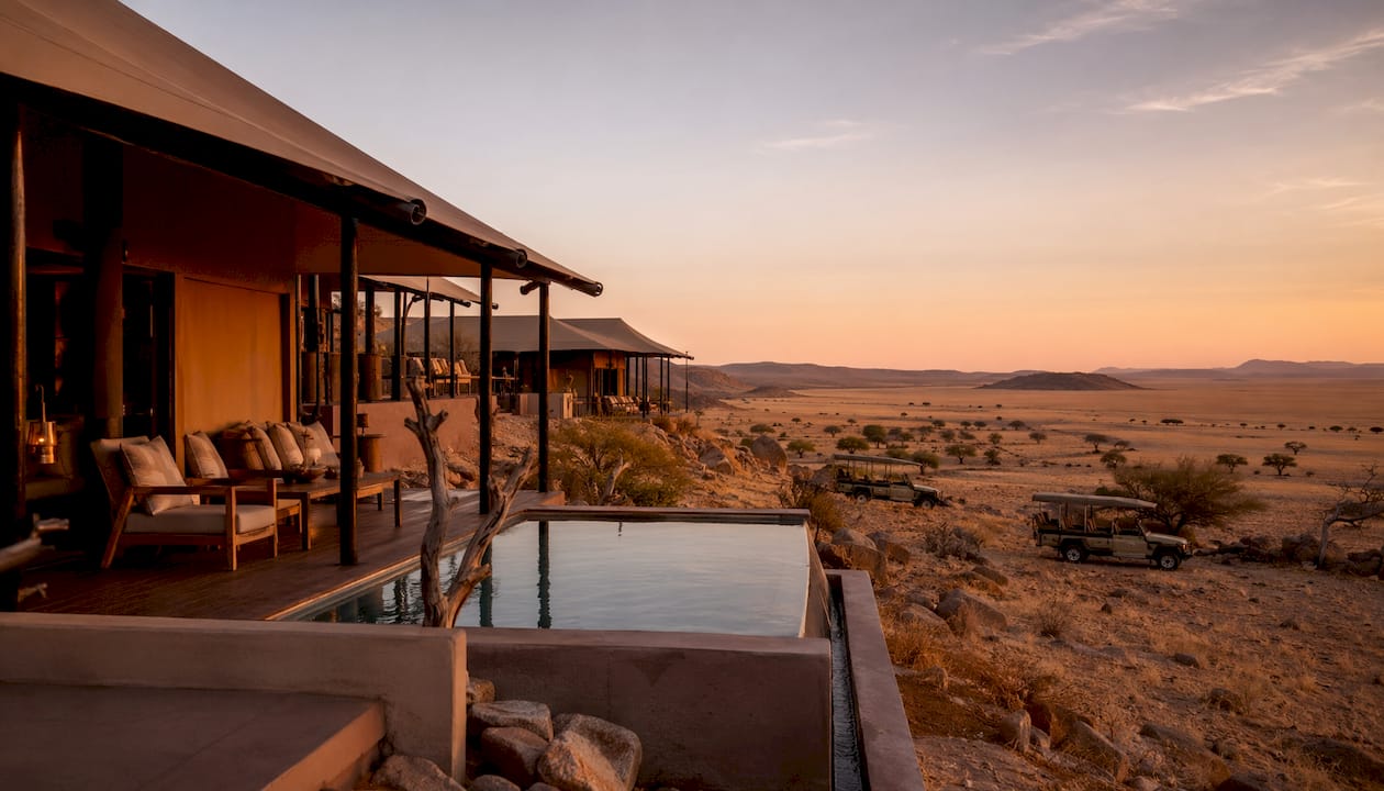 Luxury tented lodges at sunset in Namibian desert