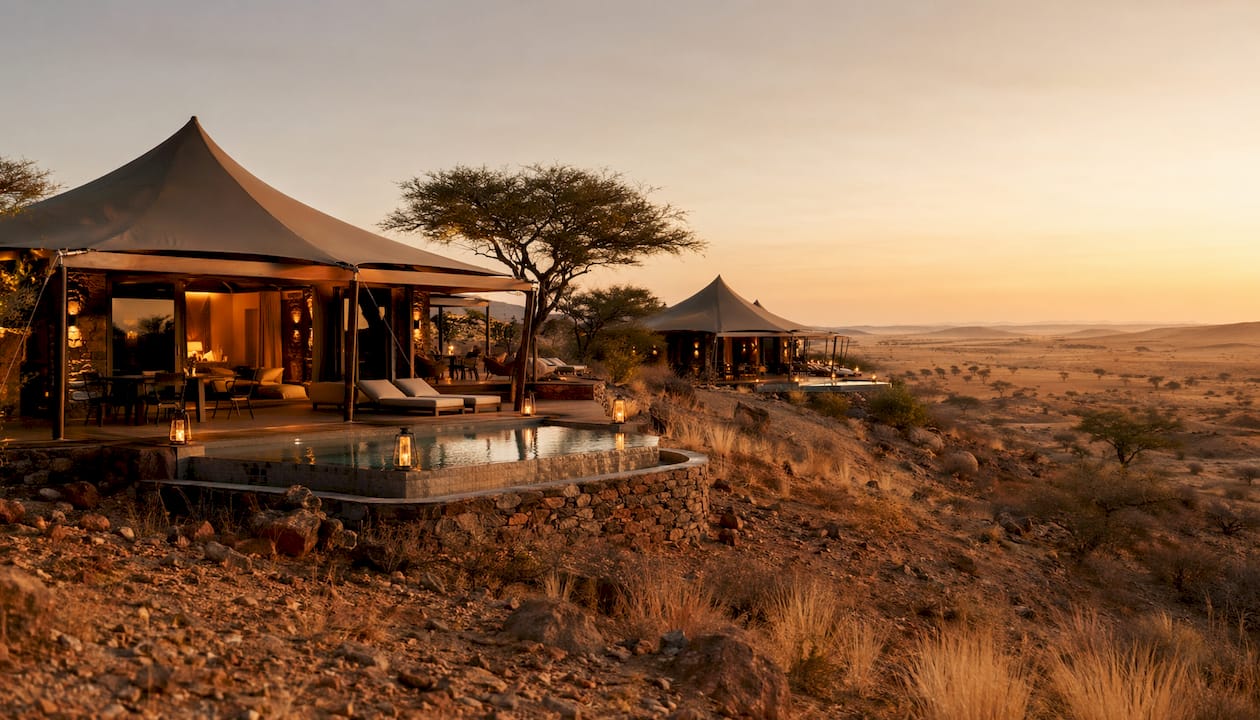 Luxury tented safari lodges at dusk in desert