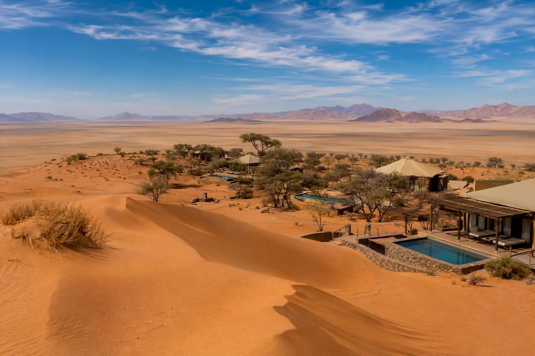Luxury lodges and desert dunes at sunrise in Namibia