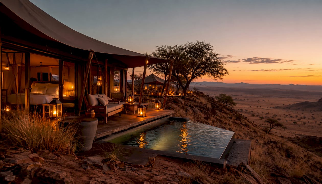 Luxury safari camp with golden dunes at dusk