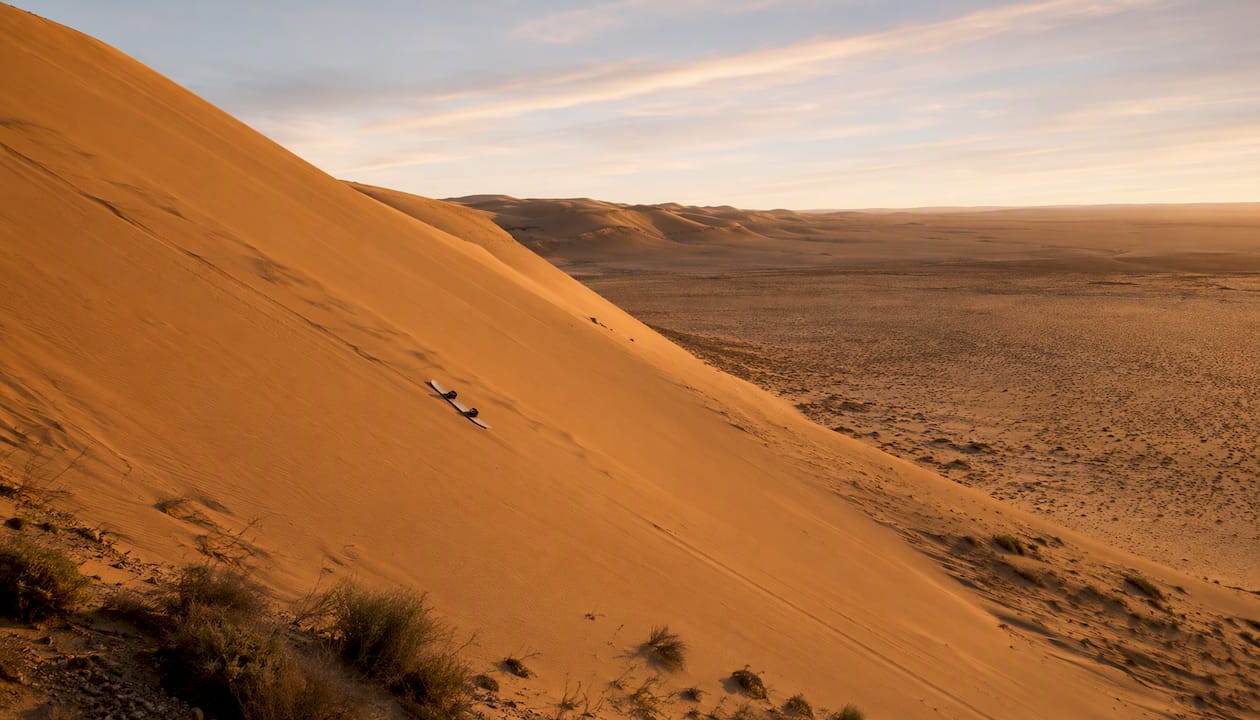 Sandboard resting on Namib desert dune