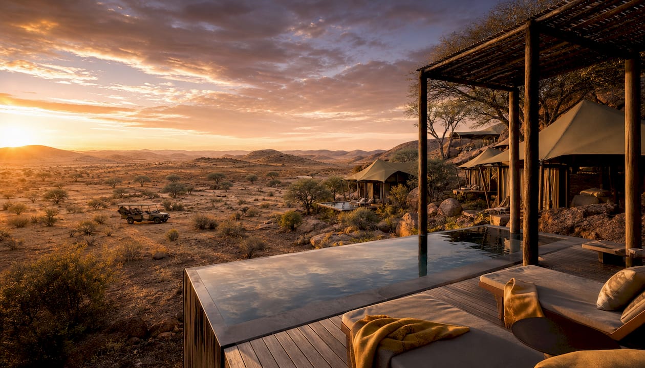 Luxury tents with desert dunes at dusk